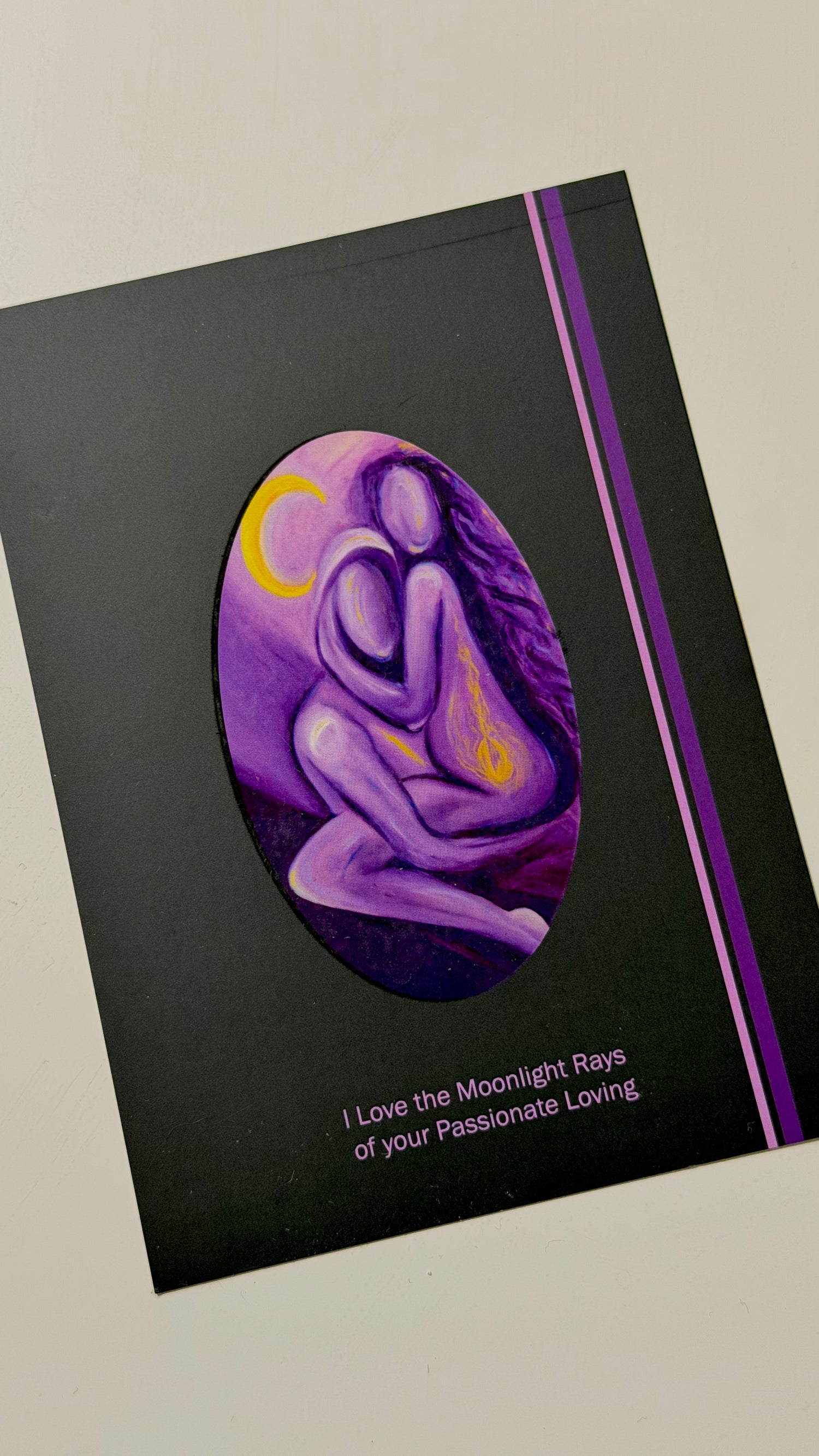 Greeting card with a purple design of couple embracing and text on a black background